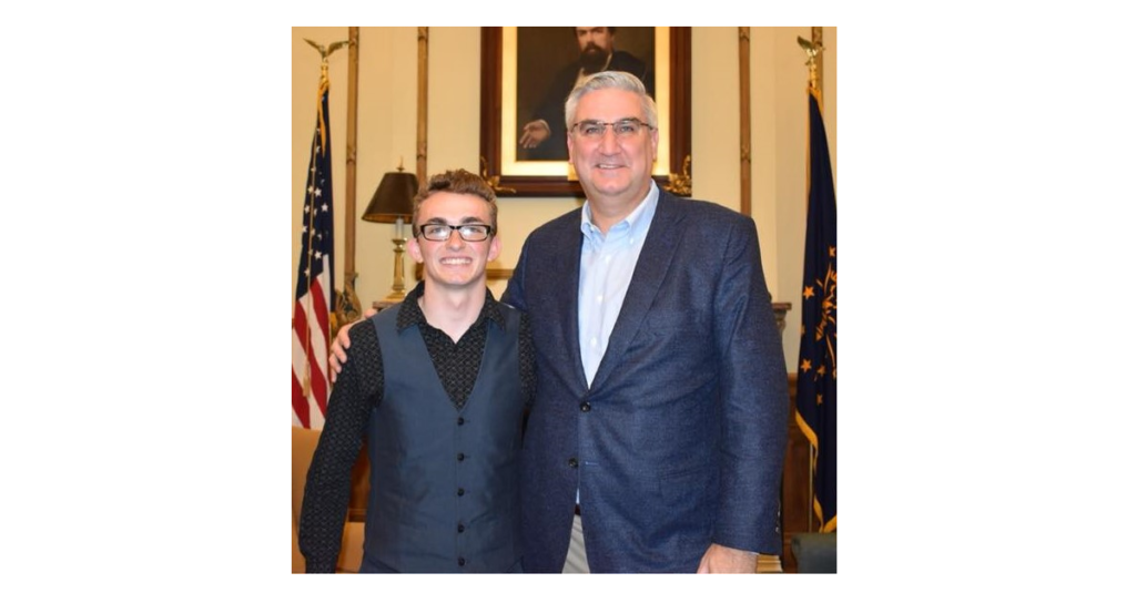 Foster Youth Joshua Christian poses with Governor Eric Holcomb.